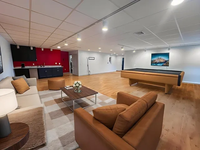 a living room with furniture a pool table and a couch