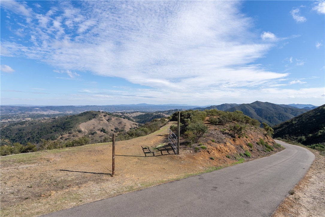 13730 Falcon Road Atascadero, CA 93422 - Photo 4 of 28 a view of a dry yard with mountains in the background