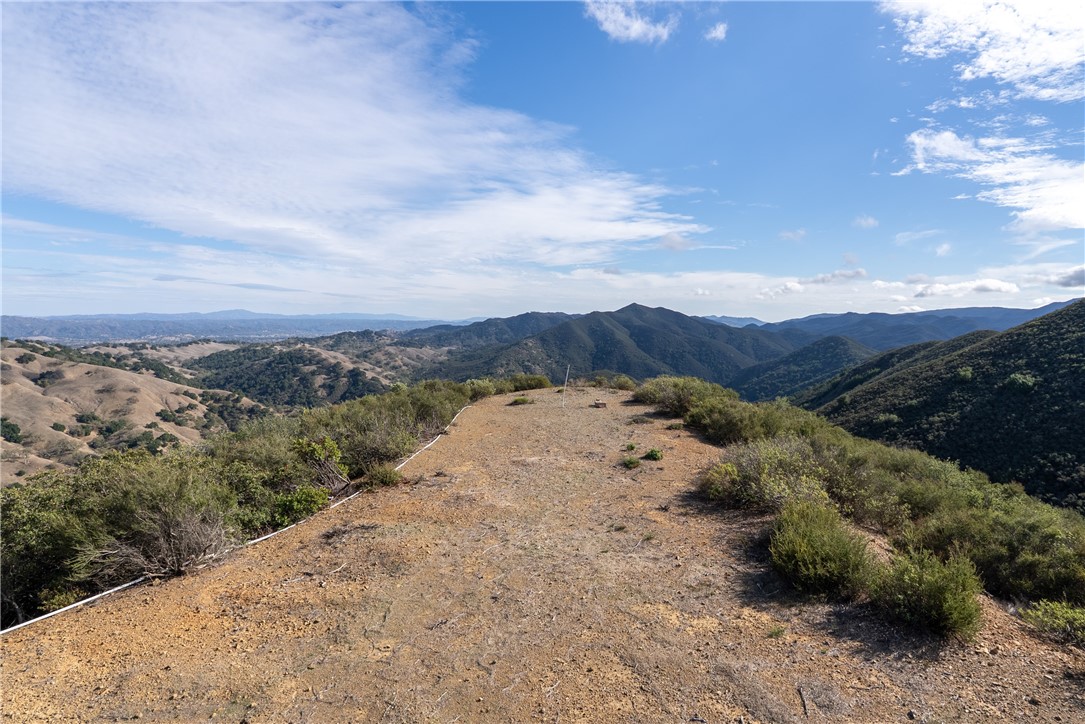13730 Falcon Road Atascadero, CA 93422 - Photo 10 of 28 a view of a dry yard with mountains in the background