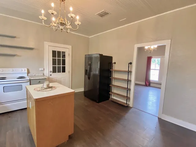 a kitchen with a refrigerator and a stove top oven