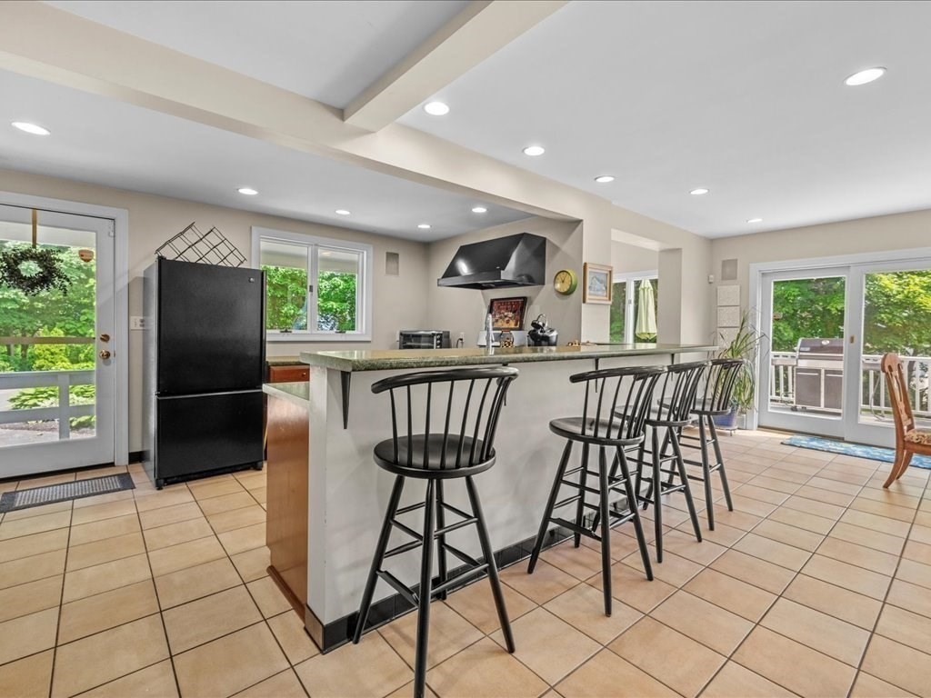 55 Dwight Street Dedham, MA 02026 - Photo 14 of 41 a kitchen with stainless steel appliances a dining table chairs and granite counter tops