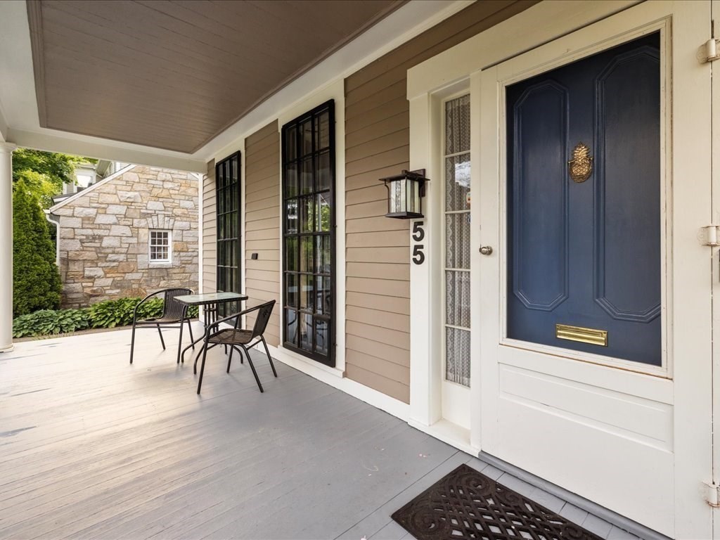 55 Dwight Street Dedham, MA 02026 - Photo 2 of 41 a view of a porch with a table and chairs and floor to ceiling window