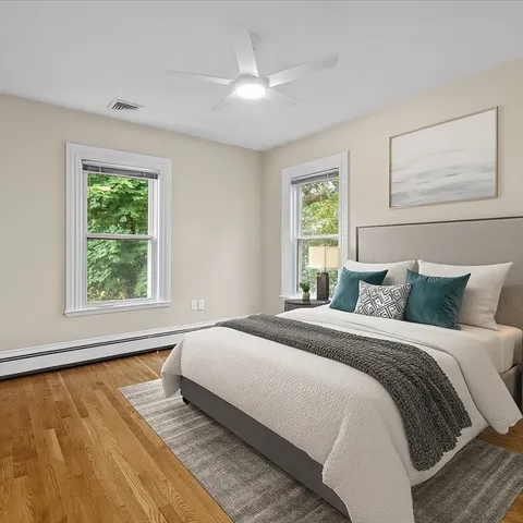 a bedroom with a bed and wooden floor