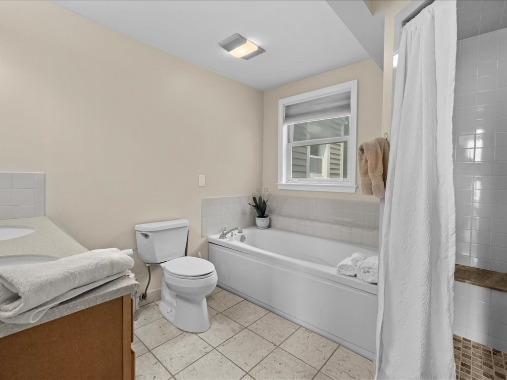 55 Dwight Street Dedham, MA 02026 - Photo 29 of 41 a bathroom with a toilet a sink and a bathtub