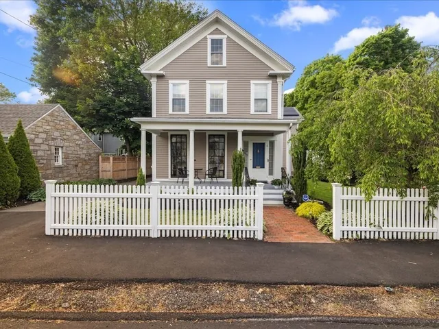 a front view of a house with a garden