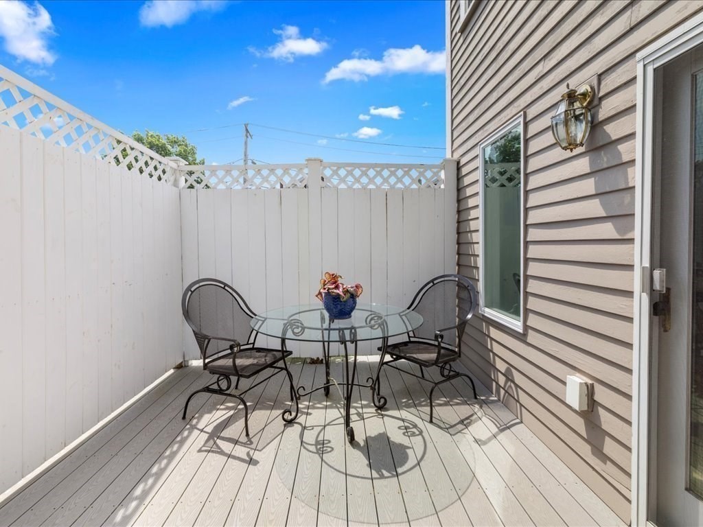 55 Dwight Street Dedham, MA 02026 - Photo 32 of 41 a view of a dinning tables and chairs in patio of the house