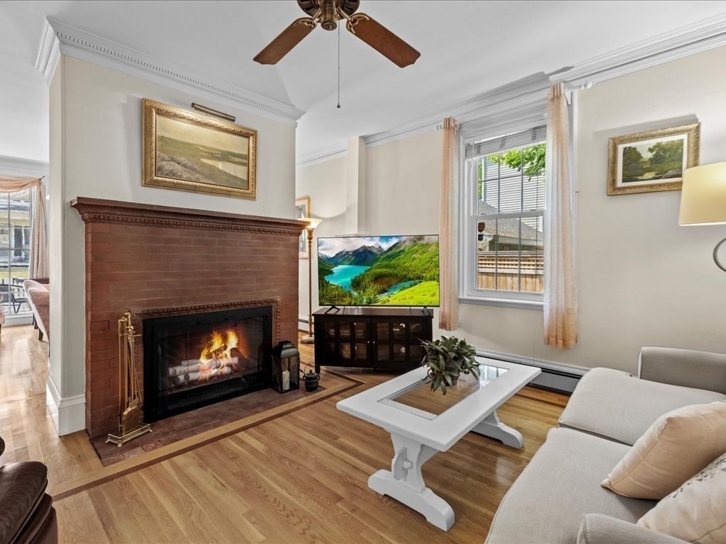 55 Dwight Street Dedham, MA 02026 - Photo 6 of 41 a living room with furniture a flat screen tv and a fireplace