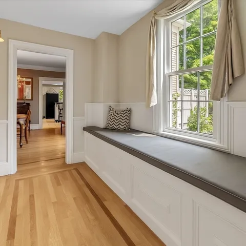 a view of hallway with a couch and wooden floor