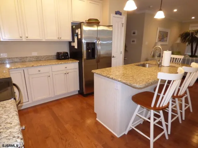 a kitchen with cabinets and chairs