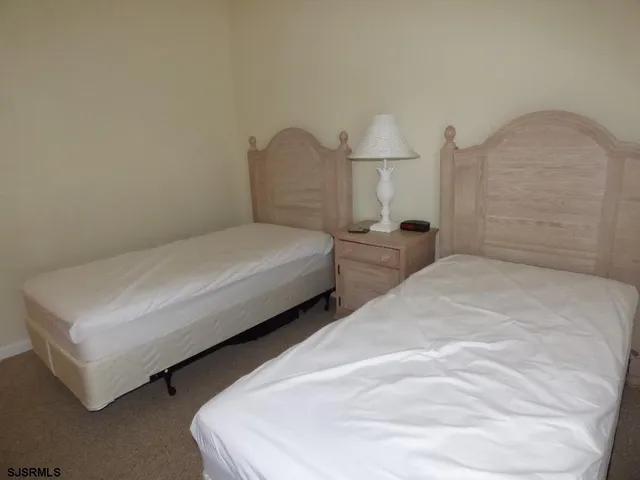 a bedroom with two beds and painted walls