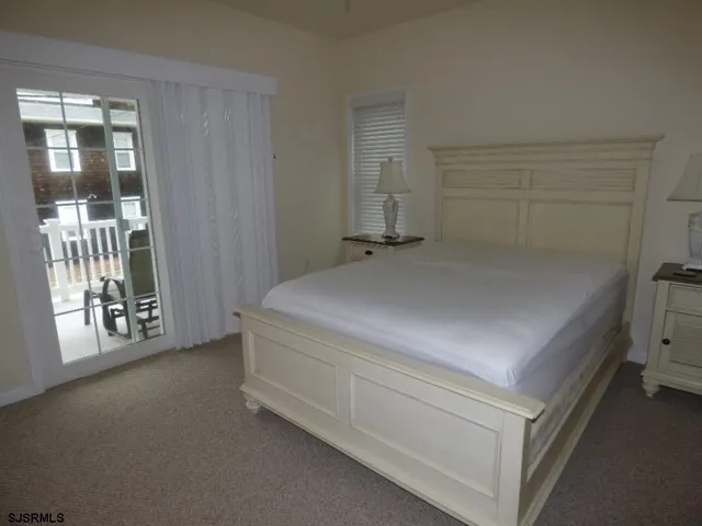 a room with a bed and glass door