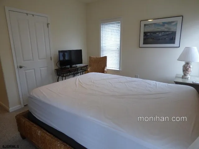 a bed sitting in a bedroom and tv