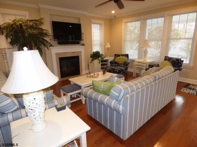 a living room with furniture fireplace and flat screen tv