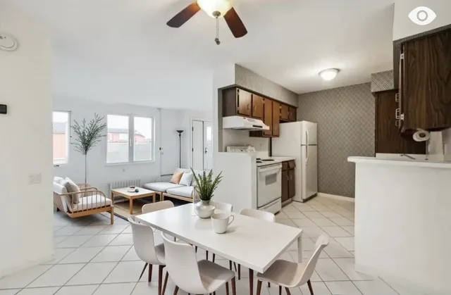a kitchen with refrigerator and cabinets