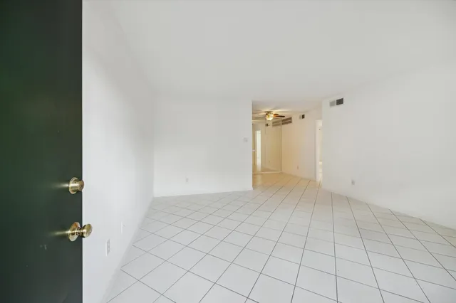 a kitchen with a refrigerator a microwave oven cabinets and a counter top space