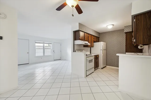 an empty room with closet and a ceiling fan