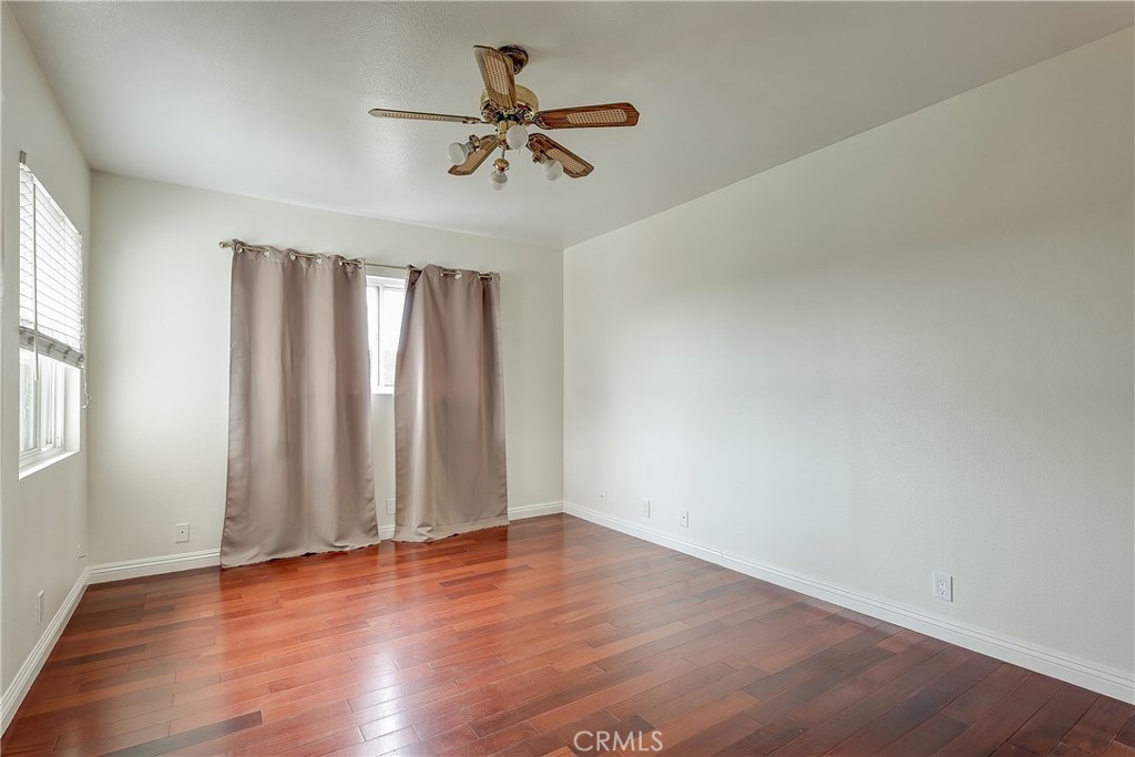 32 Blazing Star Irvine, CA 92604 - Photo 11 of 21 an empty room with wooden floor fan and windows