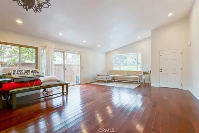 a living room with furniture window and wooden floor