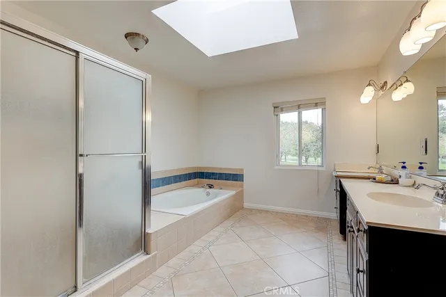 a bathroom with a tub sink and mirror