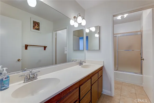 a bathroom with a sink double vanity and a mirror