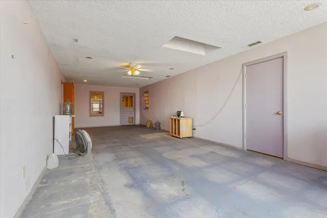 a view of a livingroom with lounge chair and a ceiling fan