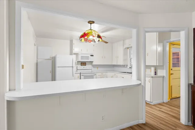 a kitchen with kitchen island a sink stainless steel appliances and cabinets