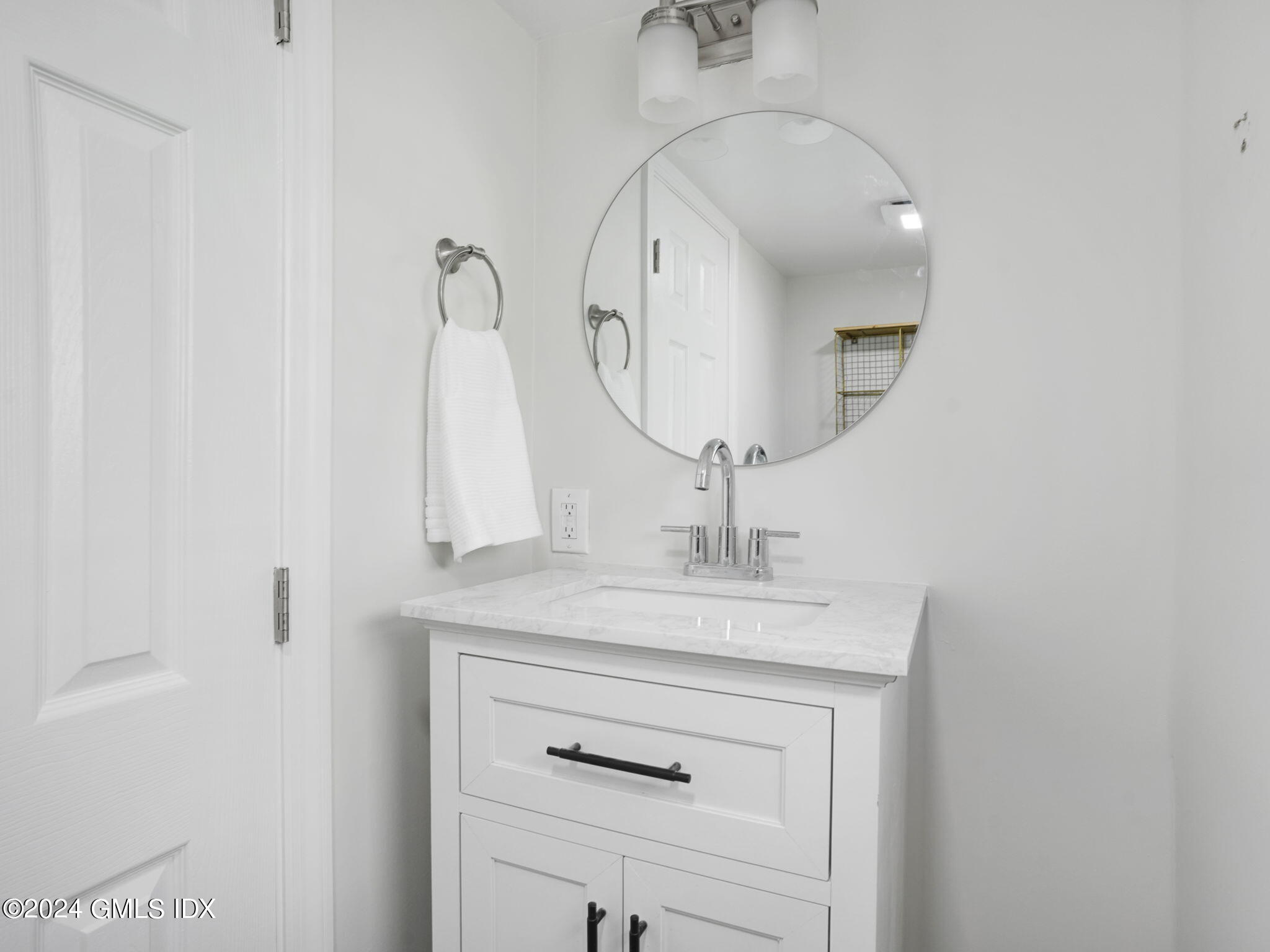 108 Henry Street Greenwich, CT 06830 - Photo 14 of 20 a bathroom with a sink vanity and a mirror