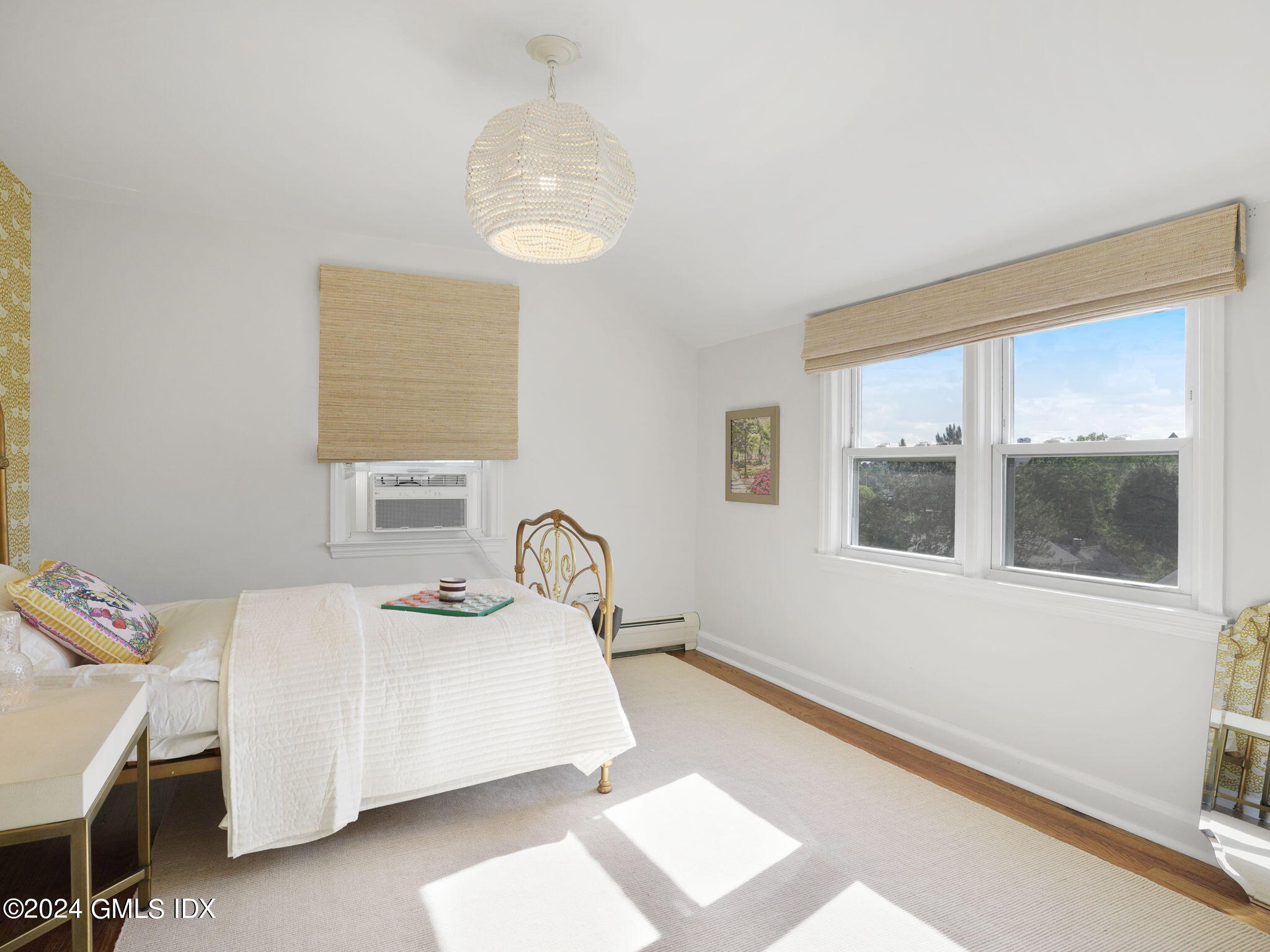 108 Henry Street Greenwich, CT 06830 - Photo 19 of 20 a bedroom with a bed and wooden floor