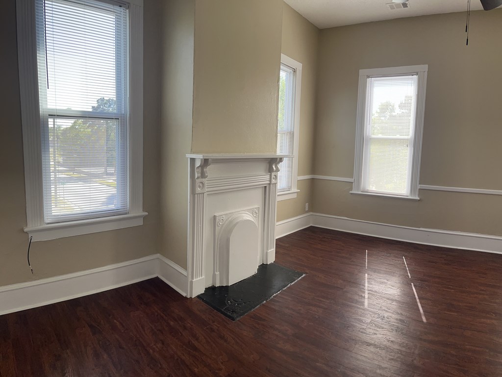 1301 18th Street, Unit B Columbus, GA 31901 - Photo 12 of 18 an empty room with wooden floor and windows
