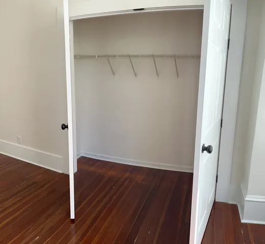 a view of a room with wooden floor