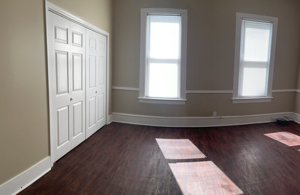 1301 18th Street, Unit B Columbus, GA 31901 - Photo 15 of 18 an empty room with wooden floor and windows