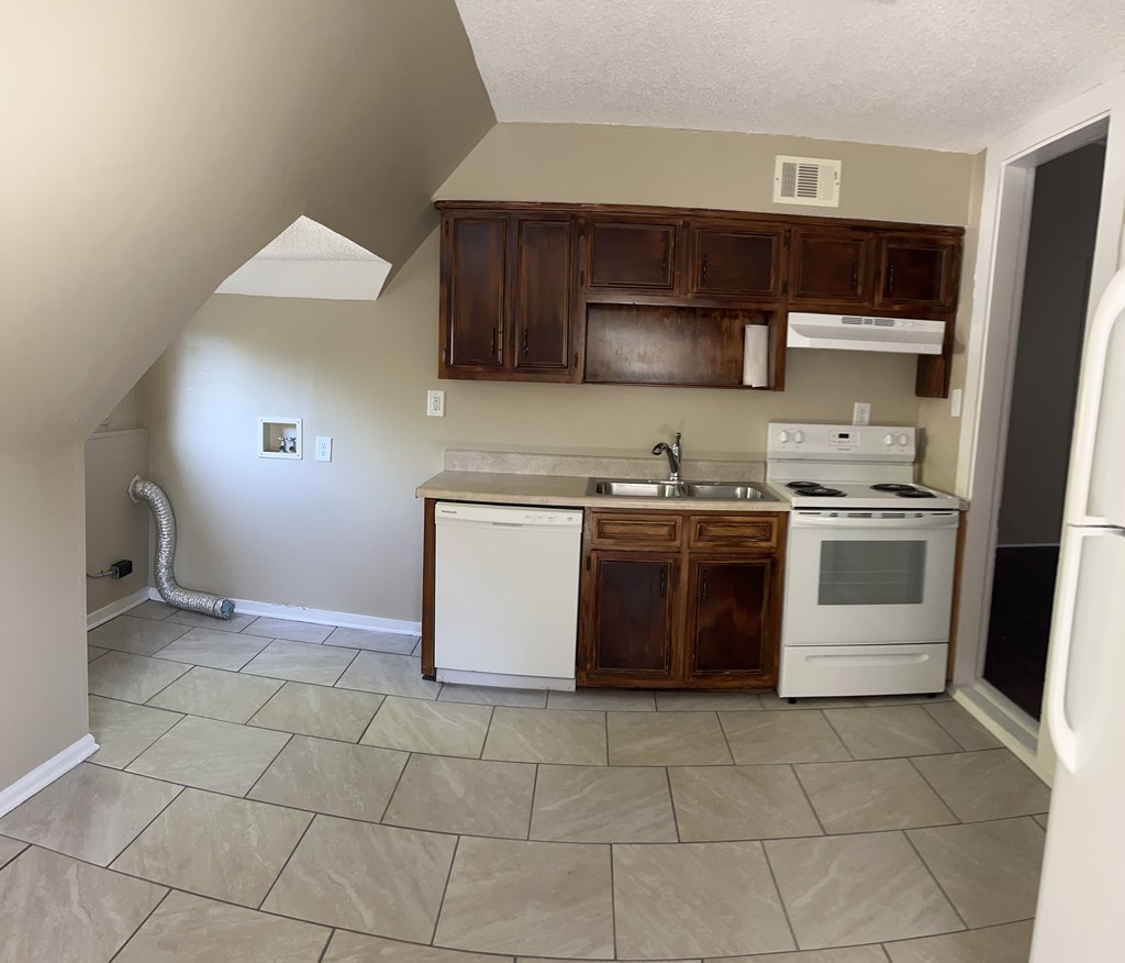 1301 18th Street, Unit B Columbus, GA 31901 - Photo 8 of 18 a kitchen with a stove top oven cabinets and a refrigerator