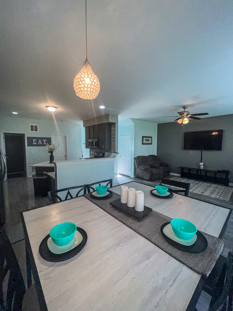 21528 Eich Drive Crest Hill, IL 60403 - Photo 12 of 23 a kitchen with a dining table and chairs with wooden floor