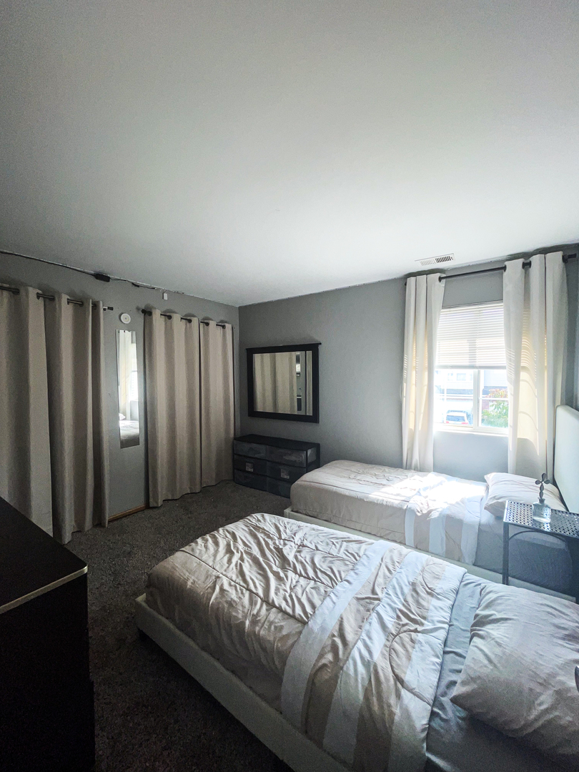 21528 Eich Drive Crest Hill, IL 60403 - Photo 18 of 23 a bedroom with a large bed and a window