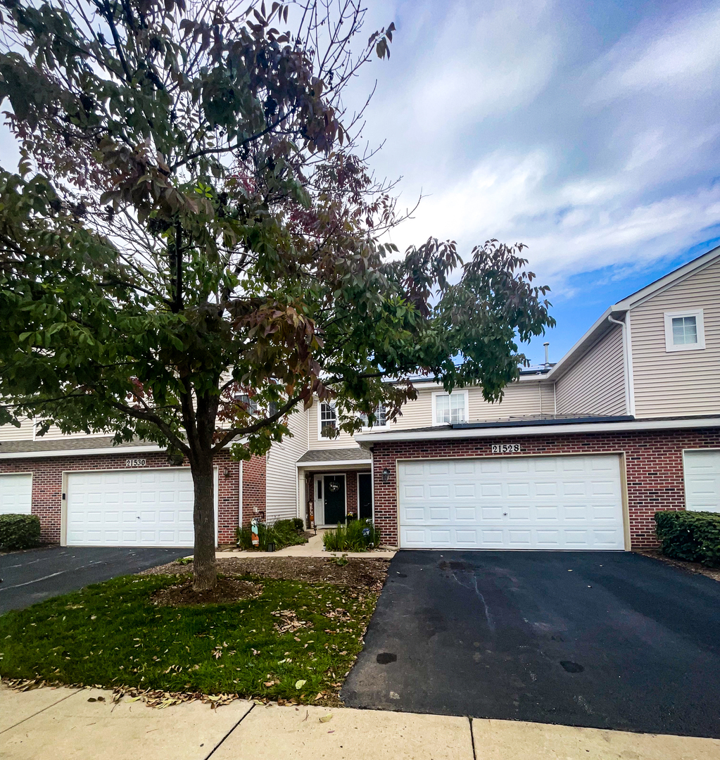 21528 Eich Drive Crest Hill, IL 60403 - Photo 2 of 23 a front view of a house with a yard and garage