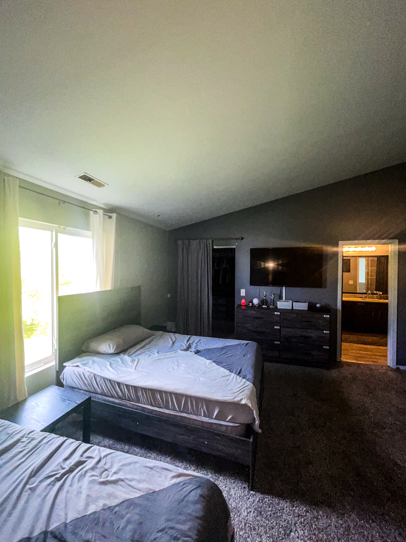 21528 Eich Drive Crest Hill, IL 60403 - Photo 21 of 23 a bedroom with a bed and a television