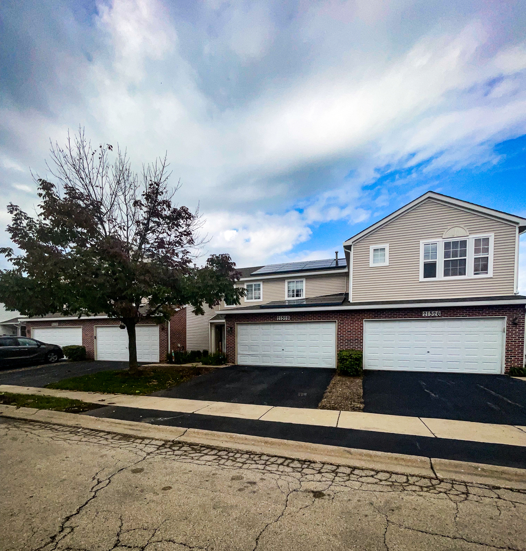 21528 Eich Drive Crest Hill, IL 60403 - Photo 3 of 23 a front view of a house with a yard