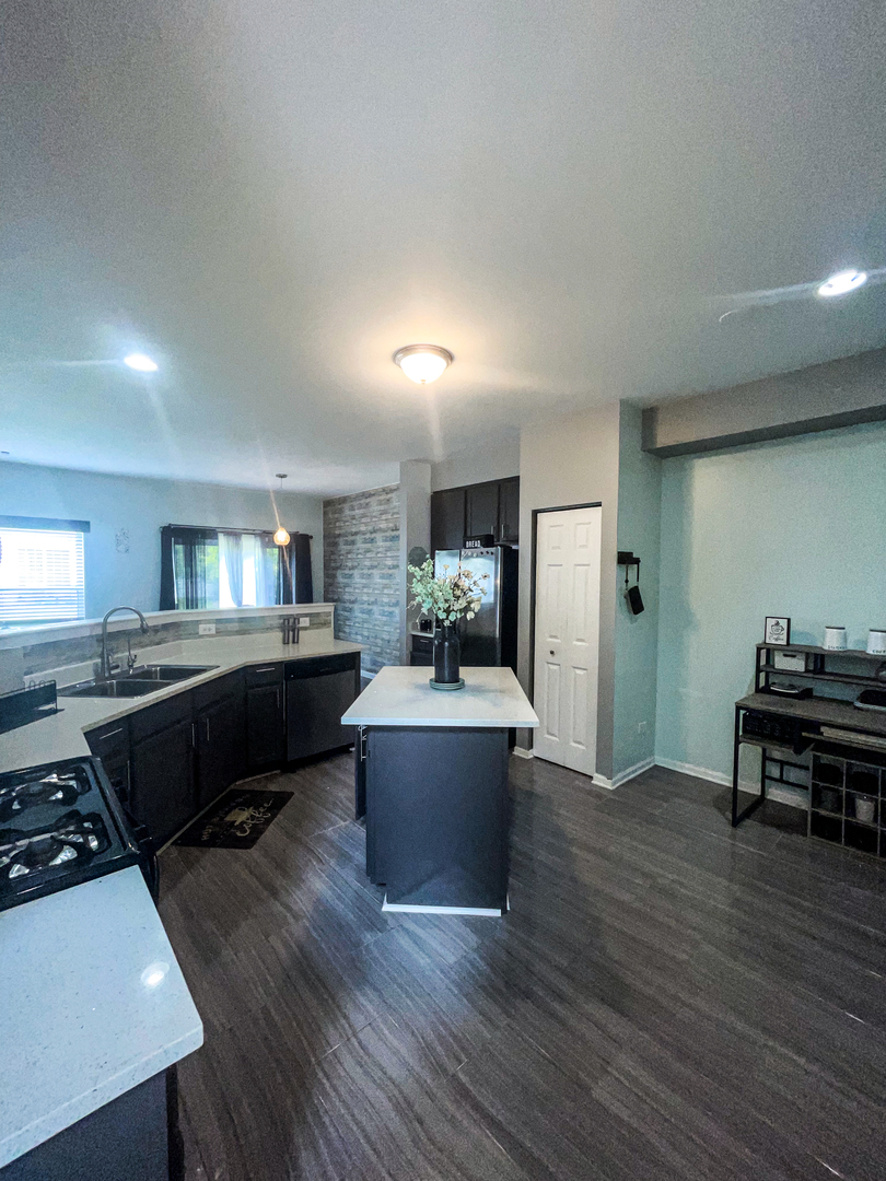 21528 Eich Drive Crest Hill, IL 60403 - Photo 8 of 23 a living room with furniture and a table