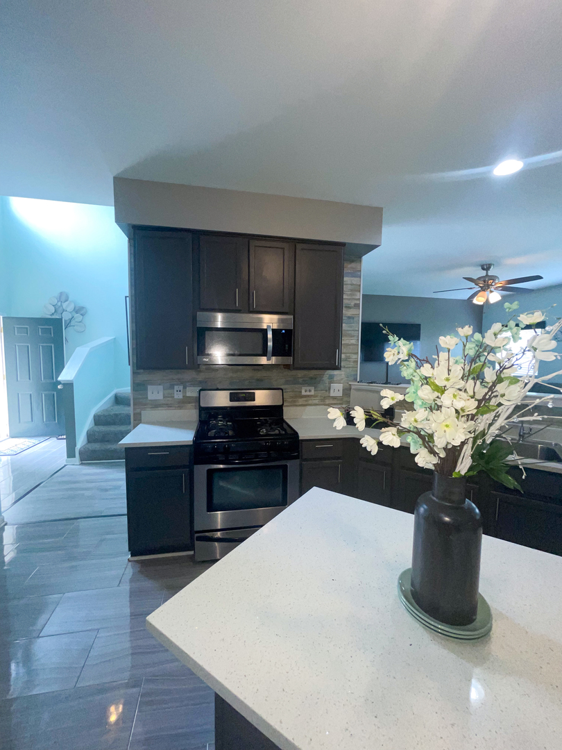 21528 Eich Drive Crest Hill, IL 60403 - Photo 9 of 23 a kitchen with a refrigerator and a stove