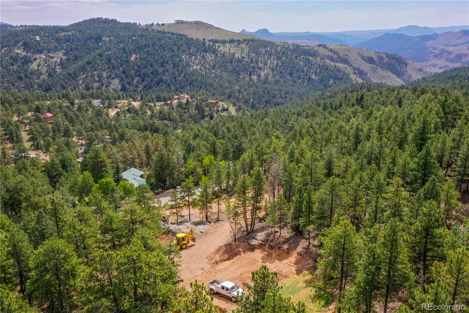 4501 County Road 72 Bailey, CO 80421 - Photo 15 of 23 a view of a lush green hillside and a building