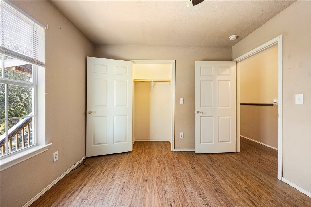 333 Mission River Oaks Road Woodsboro, TX 78393 - Photo 12 of 26 wooden floor in an empty room with a window