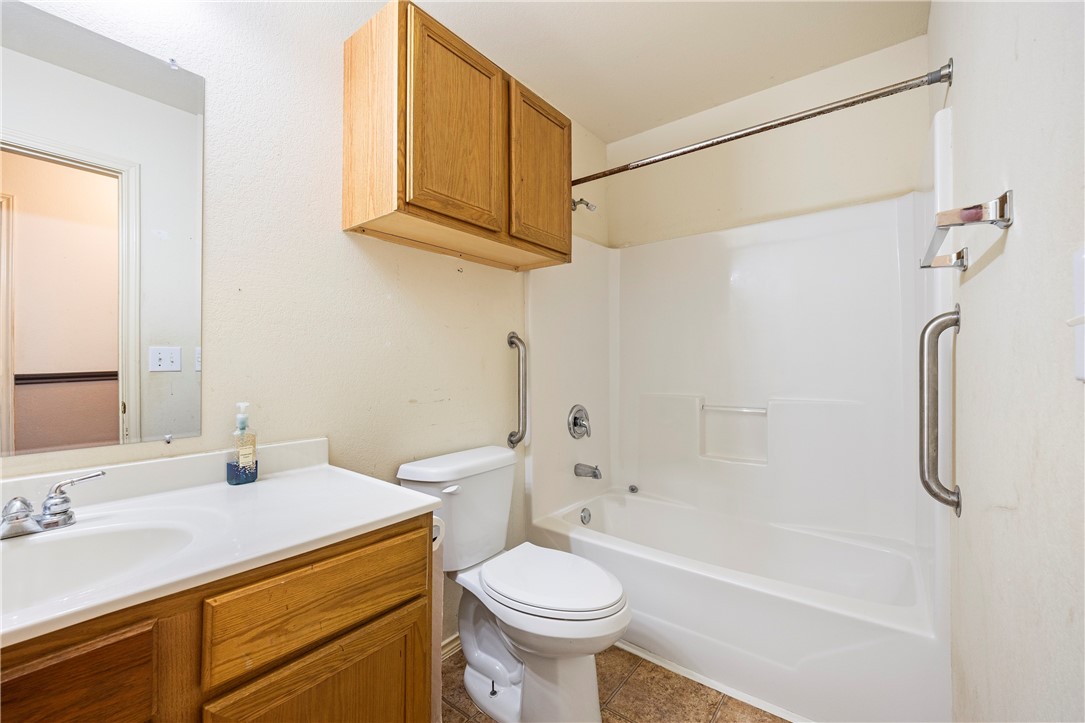 333 Mission River Oaks Road Woodsboro, TX 78393 - Photo 16 of 26 a bathroom with a sink a toilet and shower