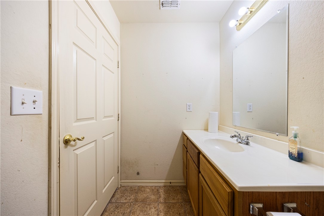 333 Mission River Oaks Road Woodsboro, TX 78393 - Photo 17 of 26 a bathroom with a sink and a mirror