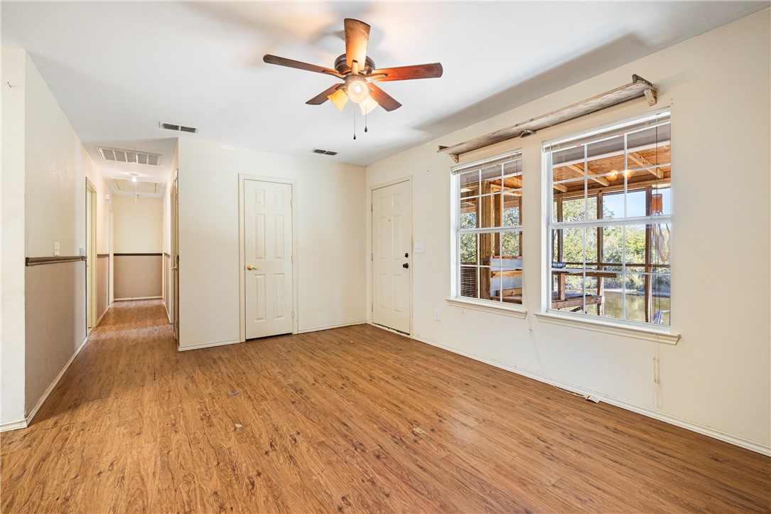 333 Mission River Oaks Road Woodsboro, TX 78393 - Photo 20 of 26 a view of empty room with wooden floor and fan