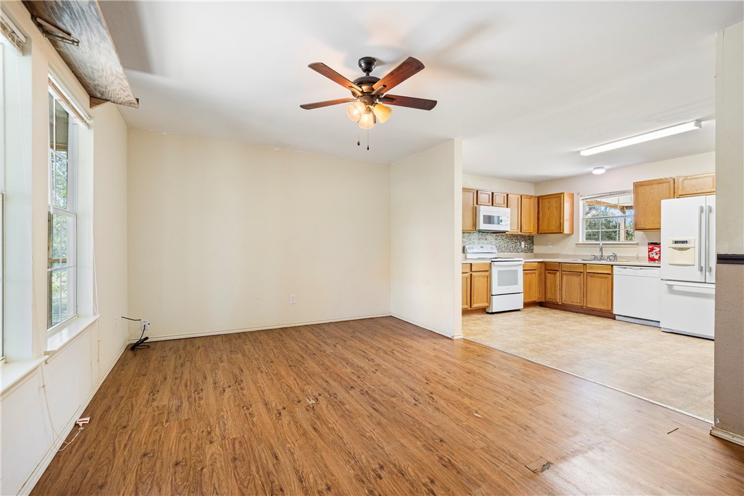 333 Mission River Oaks Road Woodsboro, TX 78393 - Photo 21 of 26 a view of open kitchen with wooden floor and window