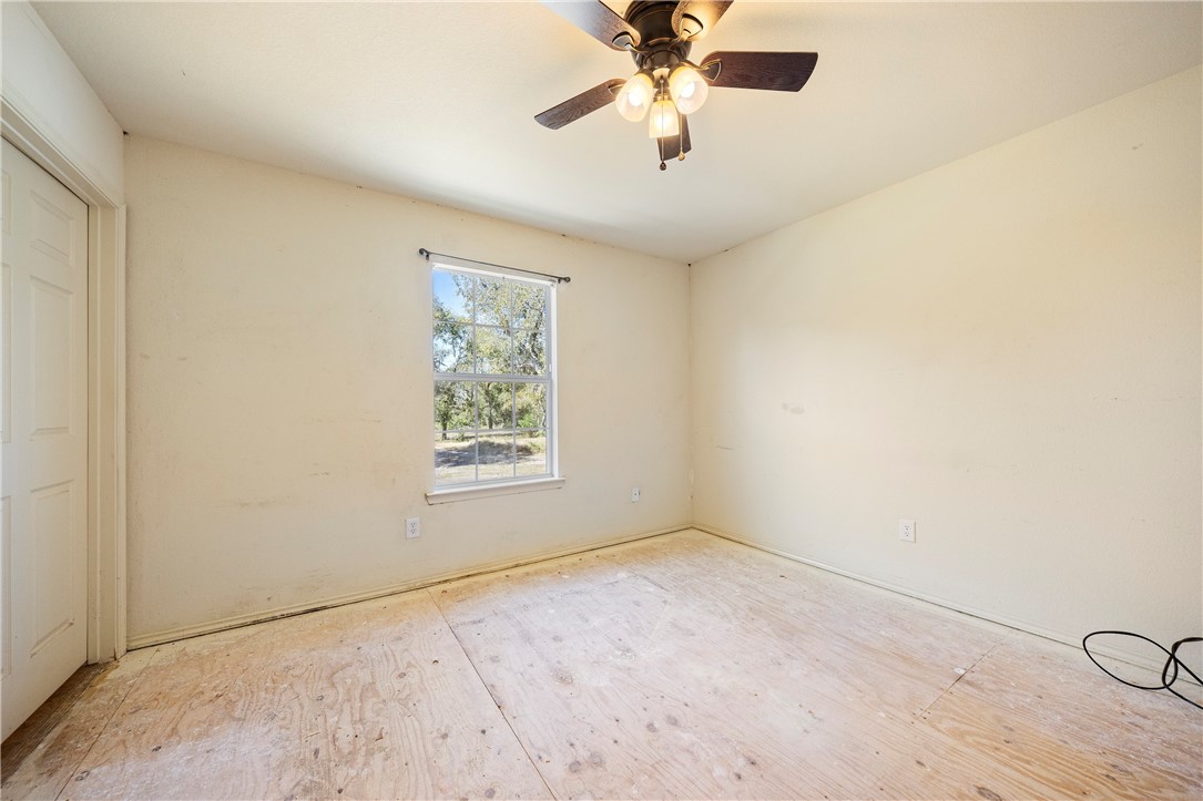 333 Mission River Oaks Road Woodsboro, TX 78393 - Photo 23 of 26 an empty room with a window and a fan