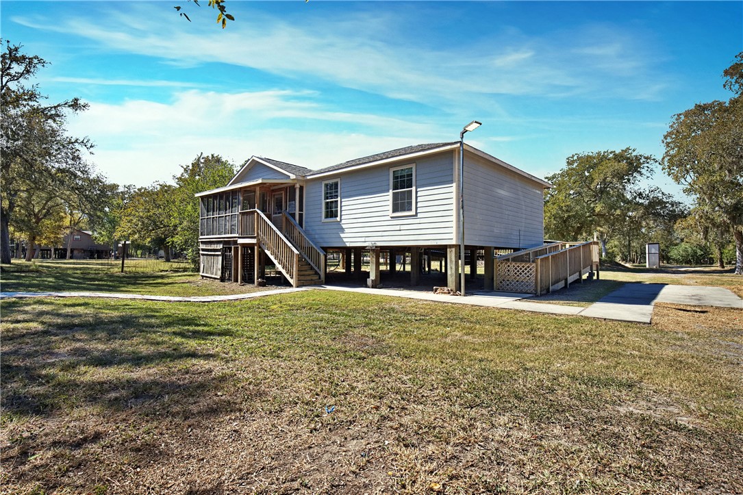 333 Mission River Oaks Road Woodsboro, TX 78393 - Photo 9 of 26 a front view of a house with a yard