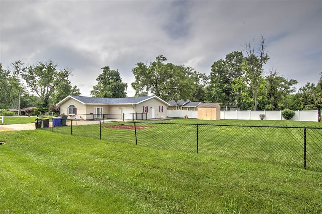 4402 East Rosewood Drive Decatur, IL 62521 - Photo 3 of 23 a house with green field in front of it