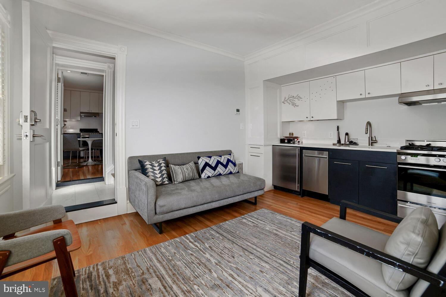 3348 Prospect Street Northwest, Unit 2 Washington, DC 20007 - Photo 2 of 11 a living room with furniture and a wooden floor