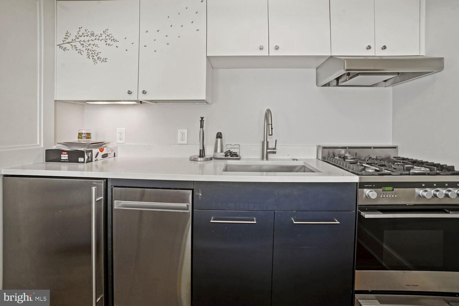 3348 Prospect Street Northwest, Unit 2 Washington, DC 20007 - Photo 4 of 11 a kitchen with stainless steel appliances granite countertop a stove a refrigerator and a white cabinets